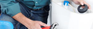 Spartan Plumber repairing a toilet